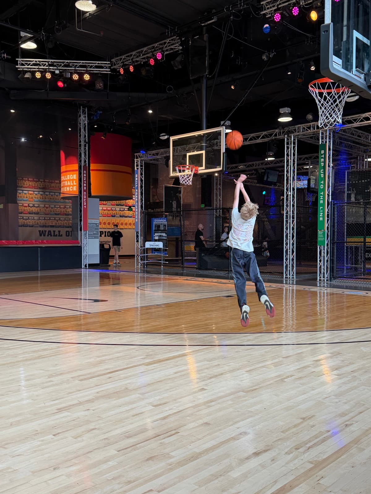 A resident going up for a shot at the College Basketball Experience