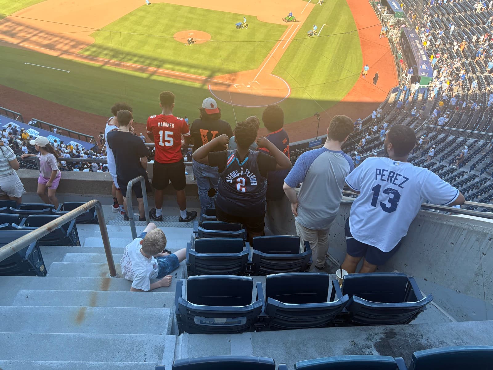 Residents at a Kansas City Royals game at sunset